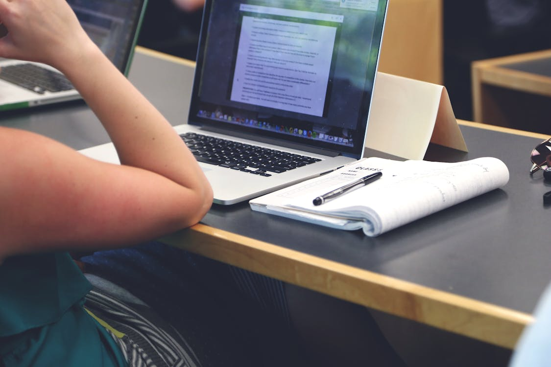 Graduate student reviewing thesis formatting and proofreading before submission