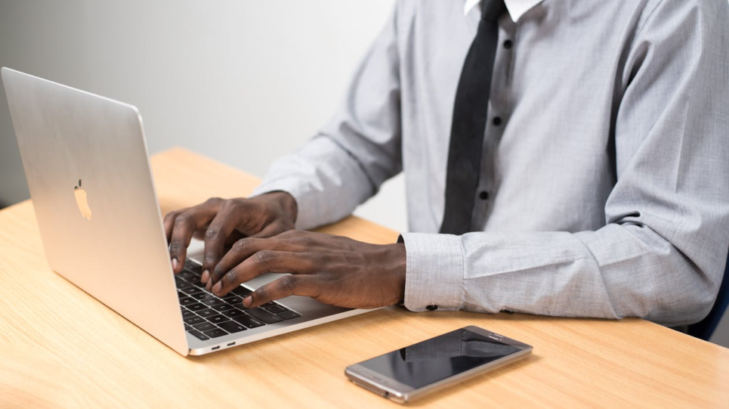 Professional academic researcher typing and revising a scientific thesis document