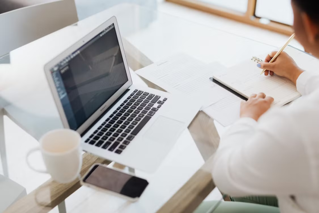 A person writes and researches their thesis.